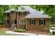 Two-story brick home with black shutters, a gray roof, and manicured landscaping at 603 Edburton Ct, Hillsborough, NC 27278