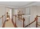Second floor hallway with beautiful hard wood floors, decorative molding, and classic trim at 603 Edburton Ct, Hillsborough, NC 27278