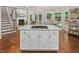 Open kitchen with an island cooktop and a view of the living and dining areas at 603 Edburton Ct, Hillsborough, NC 27278