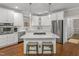 Modern kitchen with stainless steel appliances, white cabinetry, and a kitchen island at 603 Edburton Ct, Hillsborough, NC 27278