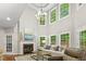 Bright living room featuring a fireplace, hardwood floors, and large windows offering natural light at 603 Edburton Ct, Hillsborough, NC 27278