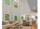 Bright living room with a soaring ceiling, large windows, and modern decor at 603 Edburton Ct, Hillsborough, NC 27278