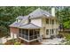 Aerial rear exterior of home with a screen porch, patio, and two car garage at 603 Edburton Ct, Hillsborough, NC 27278