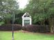 Community entrance sign with lush landscaping and mature trees at 603 Edburton Ct, Hillsborough, NC 27278