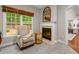 Cozy sitting area with natural light, fireplace, and a comfortable chair at 603 Edburton Ct, Hillsborough, NC 27278