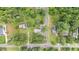 An aerial view shows how this quaint house fits in perfectly with this quiet, tree-filled neighborhood at 619 S Fifth St, Mebane, NC 27302