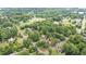 An aerial view highlighting a home's location within a neighborhood featuring tree-lined streets at 619 S Fifth St, Mebane, NC 27302