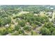 An aerial view of a residential community featuring tree-lined streets and various homes at 619 S Fifth St, Mebane, NC 27302