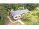 Charming single-story brick home with a well-manicured lawn, mature trees, and lush landscaping, showcasing curb appeal at 619 S Fifth St, Mebane, NC 27302