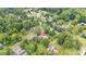 An aerial view shows how this quaint house fits in perfectly with this quiet, tree-filled neighborhood at 619 S Fifth St, Mebane, NC 27302