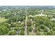 An aerial view highlighting the street and the surrounding neighborhood with lots of trees at 619 S Fifth St, Mebane, NC 27302