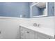 Updated bathroom featuring white vanity and blue walls with white wainscoting at 619 S Fifth St, Mebane, NC 27302