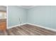 Bright bedroom featuring wood flooring and light blue walls at 619 S Fifth St, Mebane, NC 27302