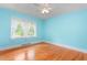 Bright bedroom featuring a ceiling fan, hardwood floors, and a window with natural light at 619 S Fifth St, Mebane, NC 27302