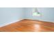 Bright bedroom with hardwood floors, soft blue walls, and natural light at 619 S Fifth St, Mebane, NC 27302