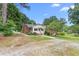 Charming single-story brick home with a covered front porch, mature trees, and well-maintained landscaping at 619 S Fifth St, Mebane, NC 27302