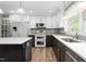 Well-lit kitchen featuring a center island and stainless steel appliances at 619 S Fifth St, Mebane, NC 27302