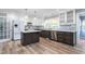 Modern kitchen with island, stainless appliances, white cabinets and tile backsplash at 619 S Fifth St, Mebane, NC 27302