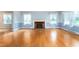Bright living room with hardwood floors, white trim, and decorative fireplace at 619 S Fifth St, Mebane, NC 27302