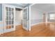 Spacious living room with hardwood floors and French doors to adjoining room at 619 S Fifth St, Mebane, NC 27302