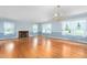 Large, sun-filled living room with hardwood floors and elegant chandelier at 619 S Fifth St, Mebane, NC 27302