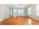 Bright living room with hardwood floors, neutral walls, and light blue accent wall at 619 S Fifth St, Mebane, NC 27302