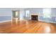 Cozy living room with brick fireplace, hardwood floors, and ample natural light at 619 S Fifth St, Mebane, NC 27302