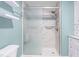 Shower featuring stylish tile, a glass door, and a rainfall shower head, offering a luxurious bathing experience at 619 S Fifth St, Mebane, NC 27302