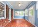 Bright sunroom with brick accents, mosaic tile flooring, and multiple windows at 619 S Fifth St, Mebane, NC 27302