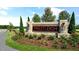Prestleigh community entrance featuring brick signage, lush landscaping, and manicured lawn at 704 Holstein Dairy Way, Wake Forest, NC 27587