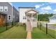 Backyard showcasing a well-maintained lawn and a charming porch with seating at 710 Vine Pkwy, Pittsboro, NC 27312