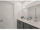 Bright bathroom featuring double sinks, gray cabinets, and a large mirror for a spacious feel at 710 Vine Pkwy, Pittsboro, NC 27312