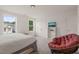 Inviting bedroom with two windows, a seating area, and ample natural light at 710 Vine Pkwy, Pittsboro, NC 27312