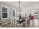 Dining area with a modern chandelier and views of the kitchen and living room at 710 Vine Pkwy, Pittsboro, NC 27312