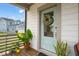 Charming front door with glass panel and a lovely wreath, enhanced by potted plants at 710 Vine Pkwy, Pittsboro, NC 27312