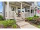Inviting front porch with seating, plants, and a wreath-adorned door at 710 Vine Pkwy, Pittsboro, NC 27312