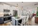 Charming kitchen with stainless steel appliances, white upper cabinets, and a cozy breakfast bar at 710 Vine Pkwy, Pittsboro, NC 27312