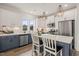 Modern kitchen featuring stainless appliances, white upper cabinets, and stylish breakfast bar at 710 Vine Pkwy, Pittsboro, NC 27312