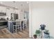 Modern kitchen featuring stainless appliances, white upper cabinets, and a stylish breakfast bar at 710 Vine Pkwy, Pittsboro, NC 27312