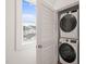 Efficient laundry room with stacked washer and dryer for space-saving convenience at 710 Vine Pkwy, Pittsboro, NC 27312