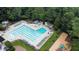 Aerial view of the community pool with ample seating and lounge areas near a playground at 7501 Montibillo Pkwy, Durham, NC 27713