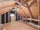 Exposed wooden beams and plywood walls showcase the unfinished attic space at 7501 Montibillo Pkwy, Durham, NC 27713