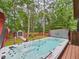 A serene backyard featuring a luxurious hot tub and shed in a lush green landscape with mature trees at 7501 Montibillo Pkwy, Durham, NC 27713