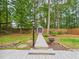 Inviting backyard with a landscaped path leading to a storage shed, perfect for outdoor activities at 7501 Montibillo Pkwy, Durham, NC 27713