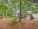 Beautifully landscaped backyard featuring a deck, screened-in porch, gazebo, and mature trees at 7501 Montibillo Pkwy, Durham, NC 27713