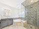 Bathroom with soaking tub, glass shower, granite countertops, and mosaic tile accents at 7501 Montibillo Pkwy, Durham, NC 27713