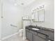 Accessible bathroom with granite countertops, and accessible toilet with grab bars at 7501 Montibillo Pkwy, Durham, NC 27713
