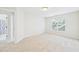 Vacant bedroom featuring neutral carpet, fresh paint and a large window and doorway to the bathroom at 7501 Montibillo Pkwy, Durham, NC 27713
