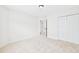 Bright bedroom with neutral carpet, fresh paint, closet, and doorway to additional rooms at 7501 Montibillo Pkwy, Durham, NC 27713