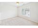 Bright bedroom with neutral carpeting, a ceiling fan, and a large window at 7501 Montibillo Pkwy, Durham, NC 27713